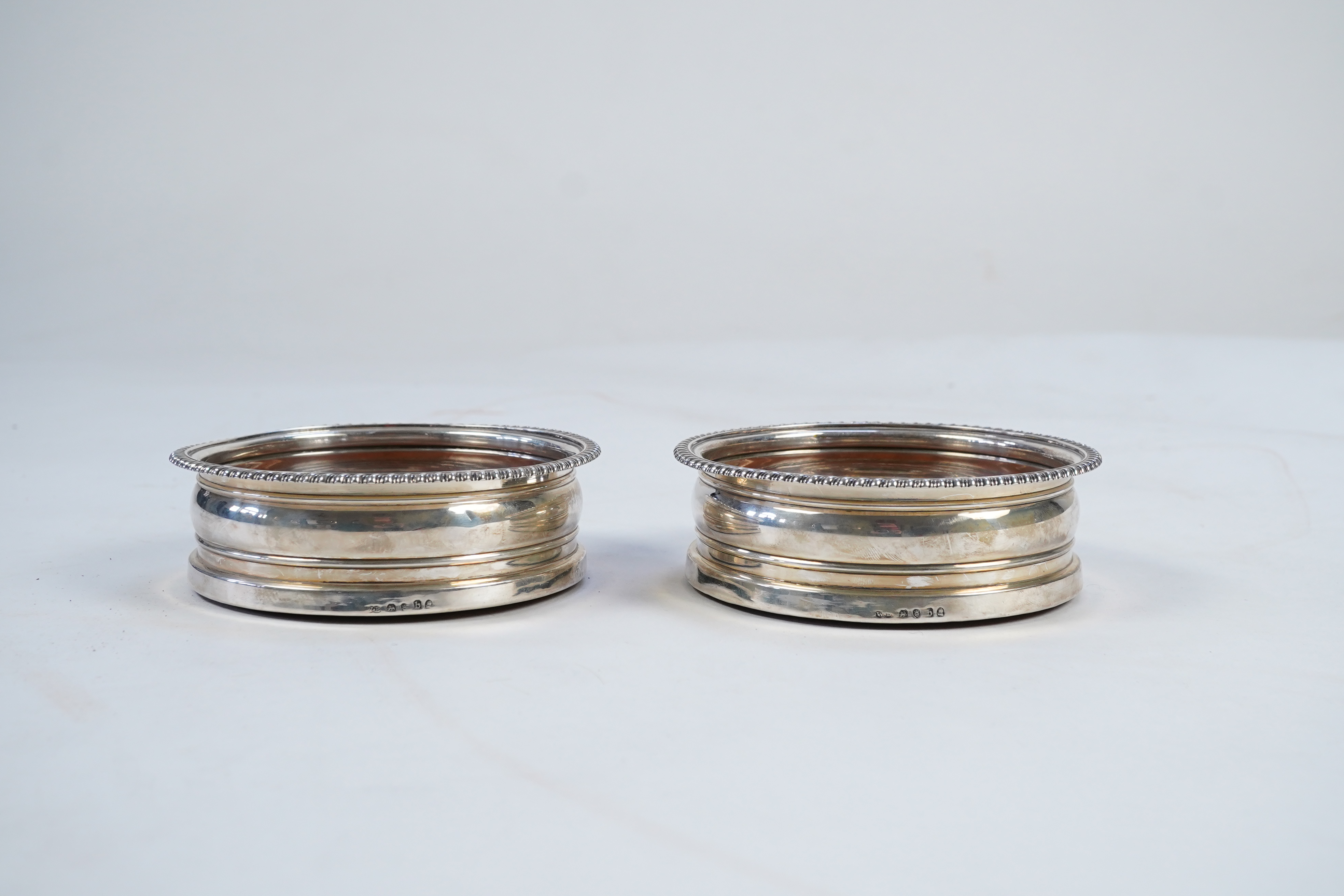 A pair of late George III silver wine coasters, by William Bateman